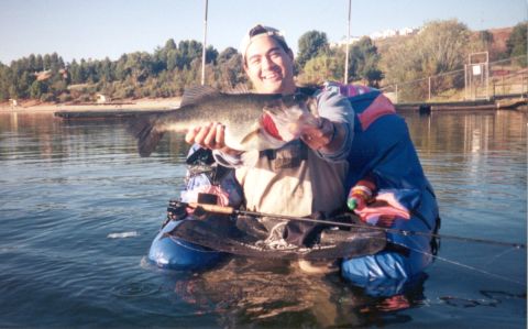 1996 Ford Bronco - A fisherman proudly displays his catch while floating on the water.