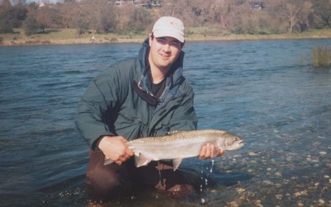 1996 Ford Bronco - A man proudly displays his catch while standing in a river.