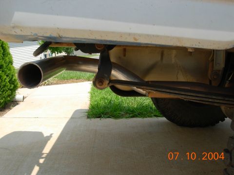 1995 Ford Bronco - Close-up view of the exhaust pipe and leaf spring assembly on a vehicle, with a date stamp of 07.10.2004.