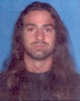 1995 Ford Bronco - A portrait of a man with long, wavy brown hair and a beard.
