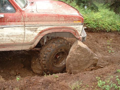 1985 Ford Bronco - This 1980s Ford truck is stuck on a rock while off-roading.