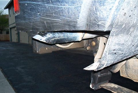 1986 Ford Bronco - The rear bumper and frame show significant damage and wear.