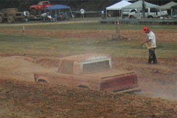 1989 Ford Bronco - Ford Bronco stuck in a mud bog with a spectator watching.