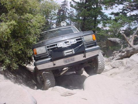 1988 Ford Bronco - This SUV appears to be from the 1980s, not a 1988 model, as it navigates a challenging rocky terrain.