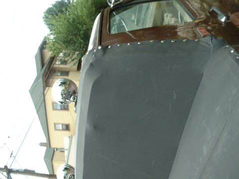 1982 Ford Bronco - Side mirror and covered door panel of a vehicle.