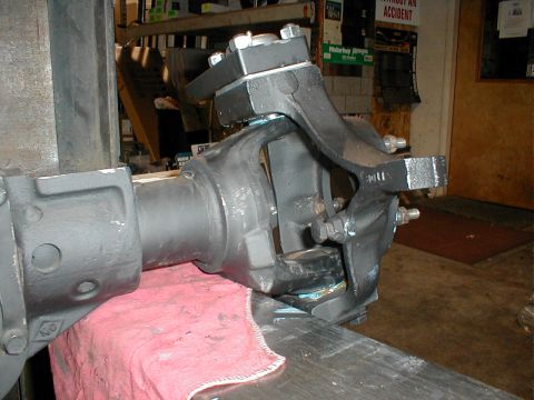1983 Ford Bronco - Close-up view of a front axle assembly, likely for an off-road vehicle, secured in a vise for repair or modification.