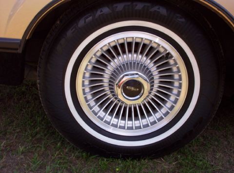 1991 Ford Crown Victoria LTD - A close-up view of a Lincoln's wheel and whitewall tire, suggesting a luxury vehicle from the late 20th century.