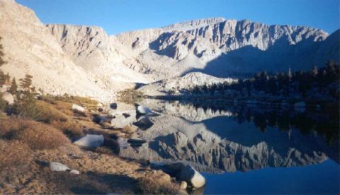 1996 Ford Bronco - A mountain lake reflects the peaks and trees under a bright blue sky.