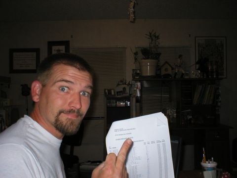 1988 Ford Bronco - A man holds up a document, possibly a vehicle registry, for the camera.