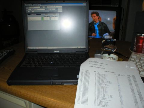 1988 Ford Bronco - A laptop computer sits on a desk next to printed reports and a can of soda.
