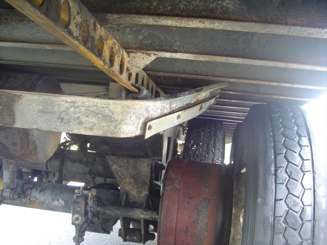Undercarriage of a truck with visible suspension components and tires
