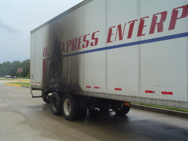 Trailer with fire damage and U.S. Xpress Enterprises logo