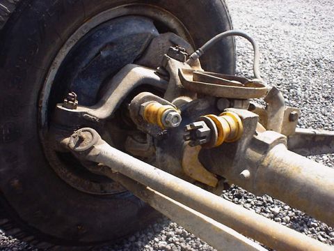 1988 Ford Bronco - This image shows the intricate mechanical details of a vehicle's suspension system, focusing on the axle and wheel assembly.