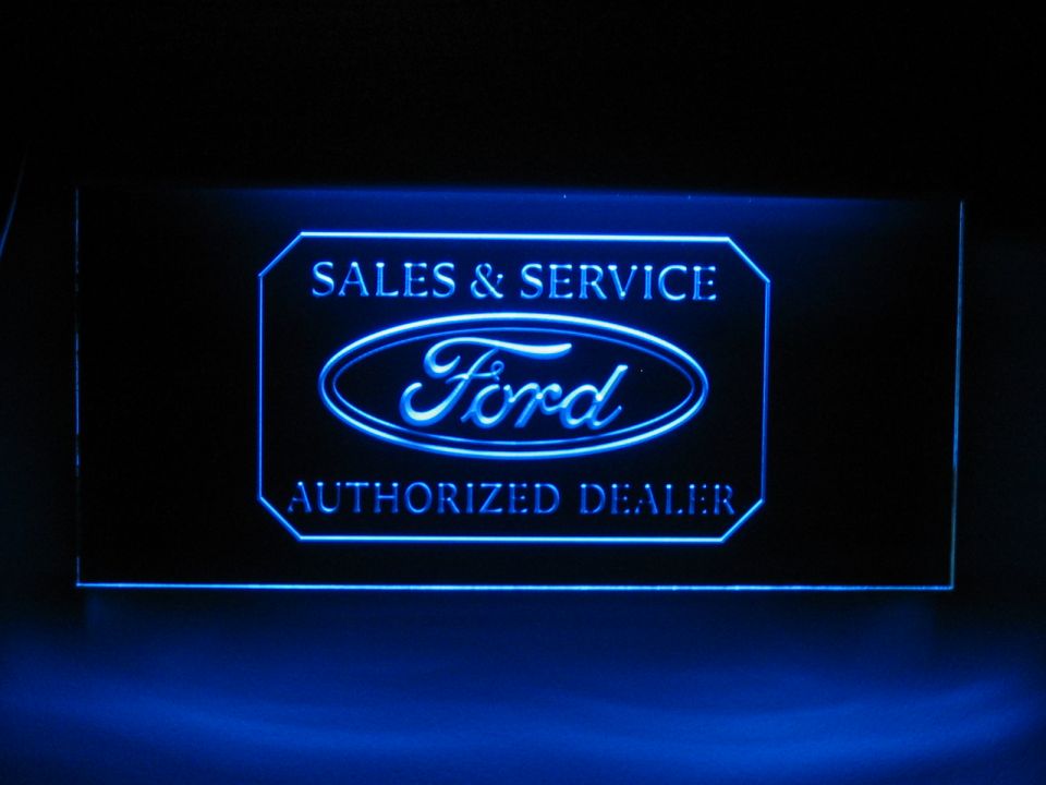 Illuminated Ford authorized dealer sign with 'Sales & Service' text