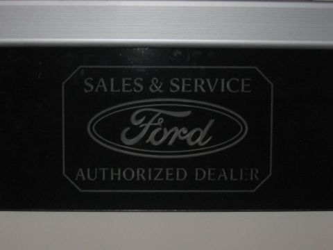 1988 Ford Bronco - Sign indicating Ford sales and service authorized dealer.