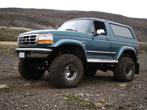 1996 Ford Bronco - This modified Ford Bronco features a lifted suspension and aggressive tires, suggesting off-road use.
