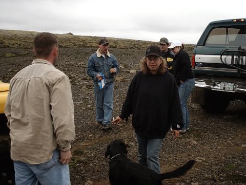 1996 Ford Bronco - A group of people and a dog stand near a green Ford Bronco in a rocky, outdoor area.