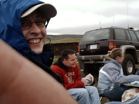 1996 Ford Bronco - A group of people are gathered outdoors with a Jeep Grand Cherokee parked behind them.