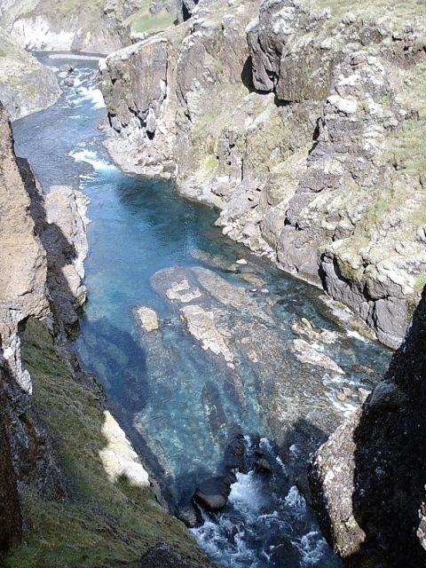 1996 Ford Bronco - A clear river winds through a deep canyon, its blue water revealing submerged rocks.