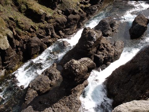 1996 Ford Bronco - A powerful river carves its path through a , rocky landscape, with white water churning over the stones.