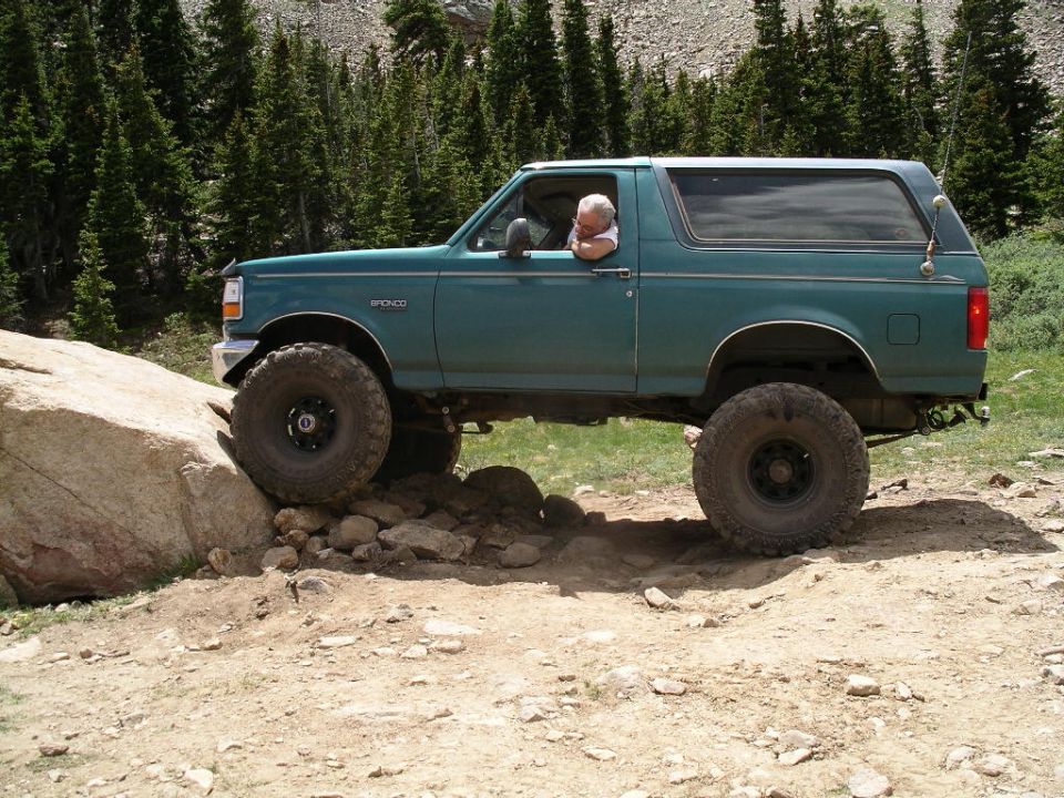 Playing on big rock at top parking lot