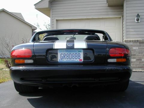1996 Dodge Viper - Rear view of a black Dodge Viper with racing stripes and a Minnesota license plate parked in a driveway.