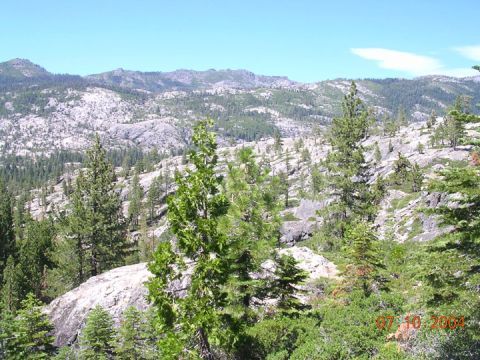 1994 Ford Bronco - A scenic view of a mountainous terrain dotted with pine trees and large rock formations, captured on July 10, 2004.