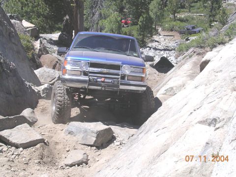 1994 Ford Bronco - A blue off-road truck maneuvers through a challenging rocky terrain, with a date stamp of 07.11.2004 visible.