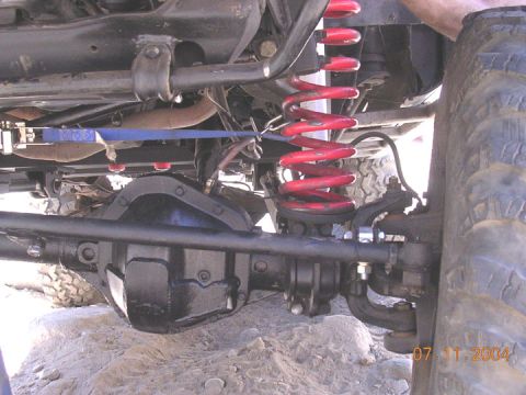 1994 Ford Bronco - With the help of 6 hands, a ratchet strap, hilift, BFH and a little creativity, we got the spring back in without removing a tire or using…