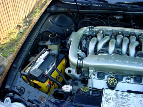 1989 Ford Taurus - Close-up of the engine bay, highlighting the SHO 24 valve engine and battery.