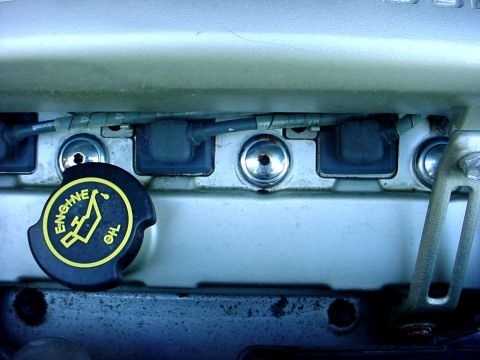 1989 Ford Taurus - Close-up view of engine components, including an oil cap and spark plug wires.