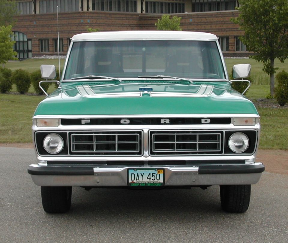 Front view of green and white 1970s Ford F-series pickup with FORD grille lettering