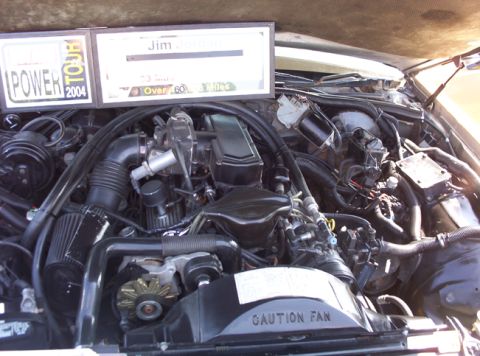 1991 Ford Crown Victoria LTD - Engine bay details with "POWER TOUR 2004" and "Jim Gothman Over 60 Miles" plaques visible.