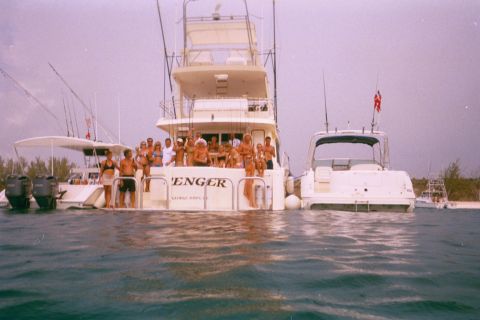 1993 Ford Bronco - A group of people enjoy a day on the water aboard two yachts and a smaller boat.