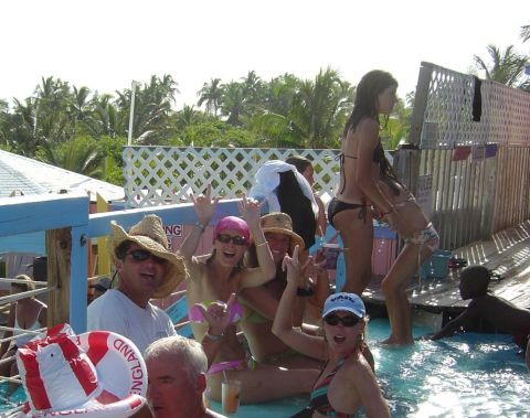 1993 Ford Bronco - A group of people enjoy a sunny day at a tropical pool party.