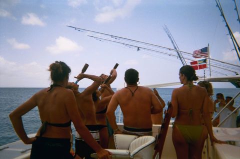 1993 Ford Bronco - A group of people are on a boat, enjoying drinks and the ocean view.