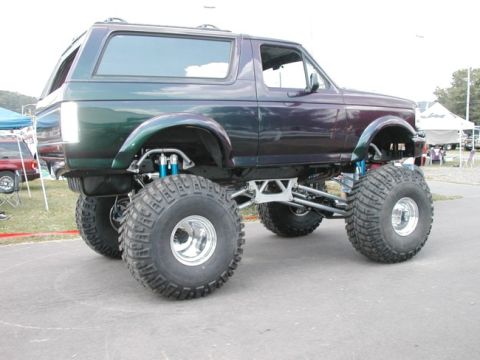 1994 Ford Bronco - This heavily modified Ford Bronco features a significant lift kit and massive tires for off-road use.