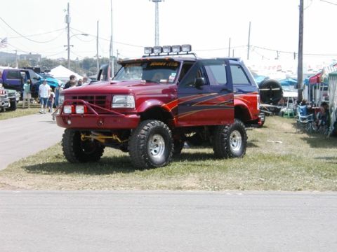 1994 Ford Bronco - Modified 1994 Ford Bronco on display at an outdoor event, custom paint and off-road modifications.