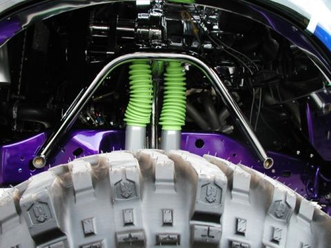 1994 Ford Bronco - Customized engine bay with off-road suspension and large tires, suggesting a modified vehicle.