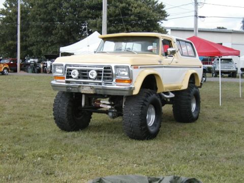 1994 Ford Bronco - This modified Ford Bronco features a significant lift kit and oversized tires, giving it a commanding presence.
