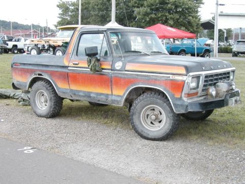 1994 Ford Bronco - This Ford Bronco features a distinctive orange and red gradient paint scheme on its side.