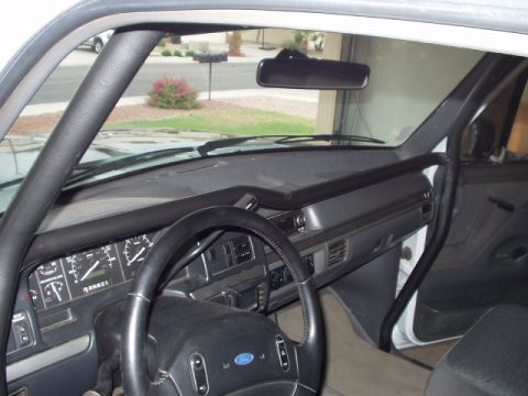 1993 Ford Bronco - The interior of a 1993 Ford Bronco features a roll cage and a clear view of the dashboard and steering wheel.