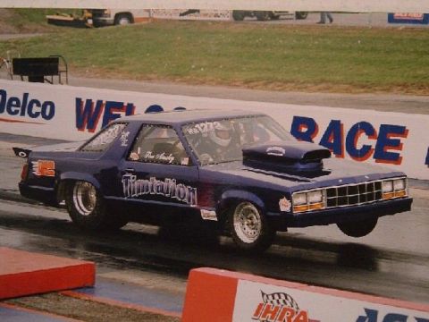 1978 Ford Bronco - Drag racing car with hood scoop and racing slicks on a track.