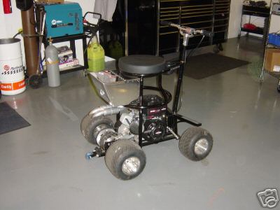 1978 Ford Bronco - A custom-built go-kart with a seat and engine is parked in a garage with tools in-progress welding equipment in the background.