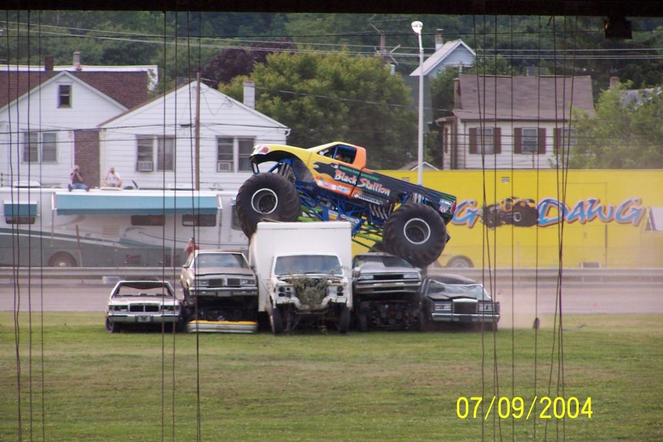 Monster truck named Black Stallion crushing cars