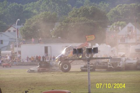 1979 Ford Bronco - Monster truck event with cars being crushed, a flag reads 'GEIST'.