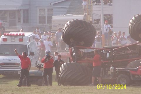 1979 Ford Bronco - A monster truck event is underway with spectators and emergency vehicles present.