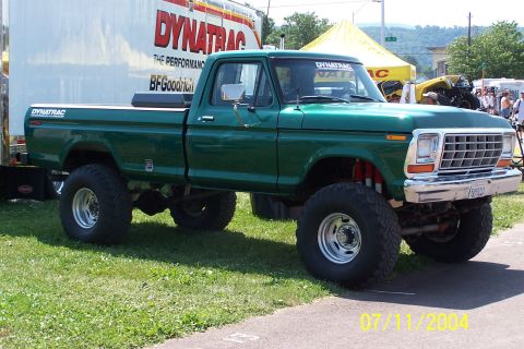 1979 Ford Bronco - This lifted green pickup truck has a prominent grille and large tires, suggesting a model year around 1978.