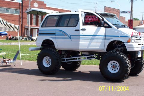 1979 Ford Bronco - A modified van with oversized tires and a raised suspension sits on pavement.
