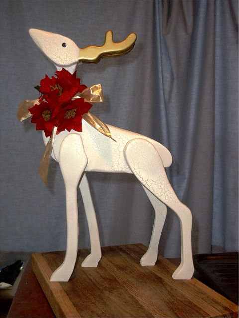 1979 Ford Bronco - Decorative wooden reindeer with festive red flowers and a gold bow.